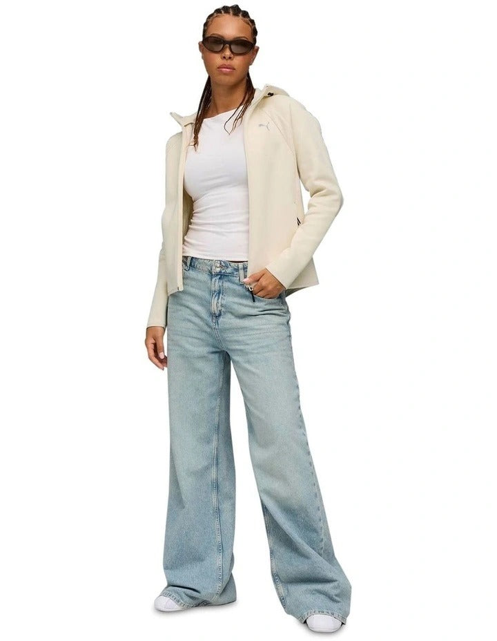 Person wearing a beige hoodie and sunglasses on a white background