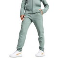 Person wearing a light green tracksuit with white sneakers on a white background