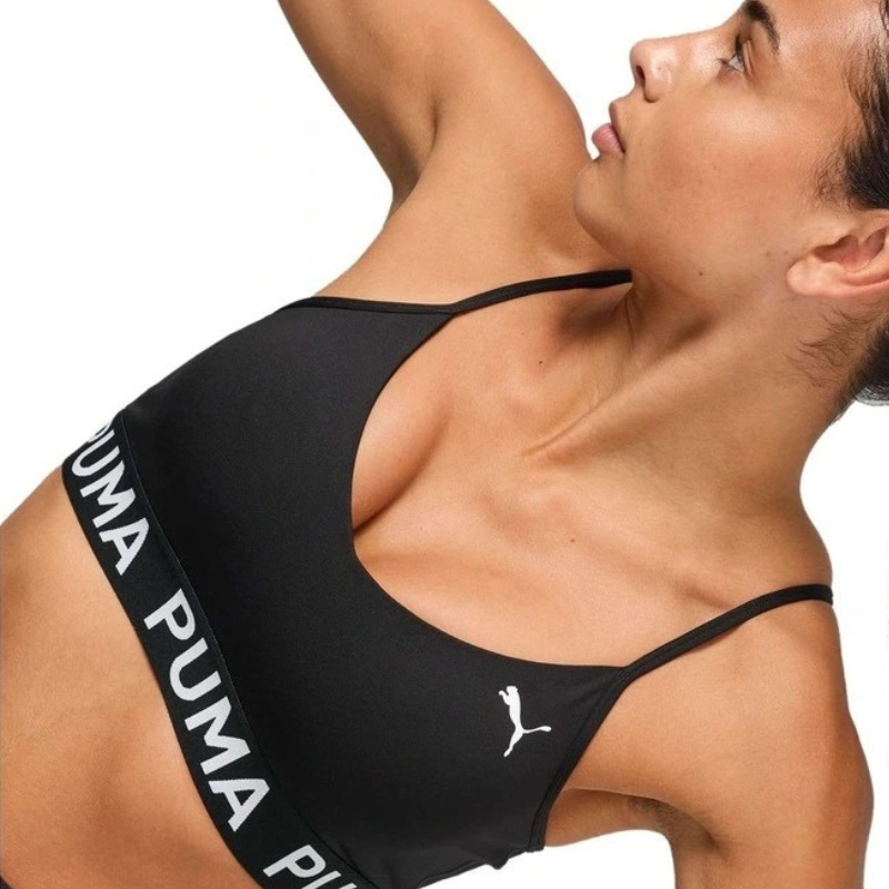 Black Puma sports bra on a model against a white background