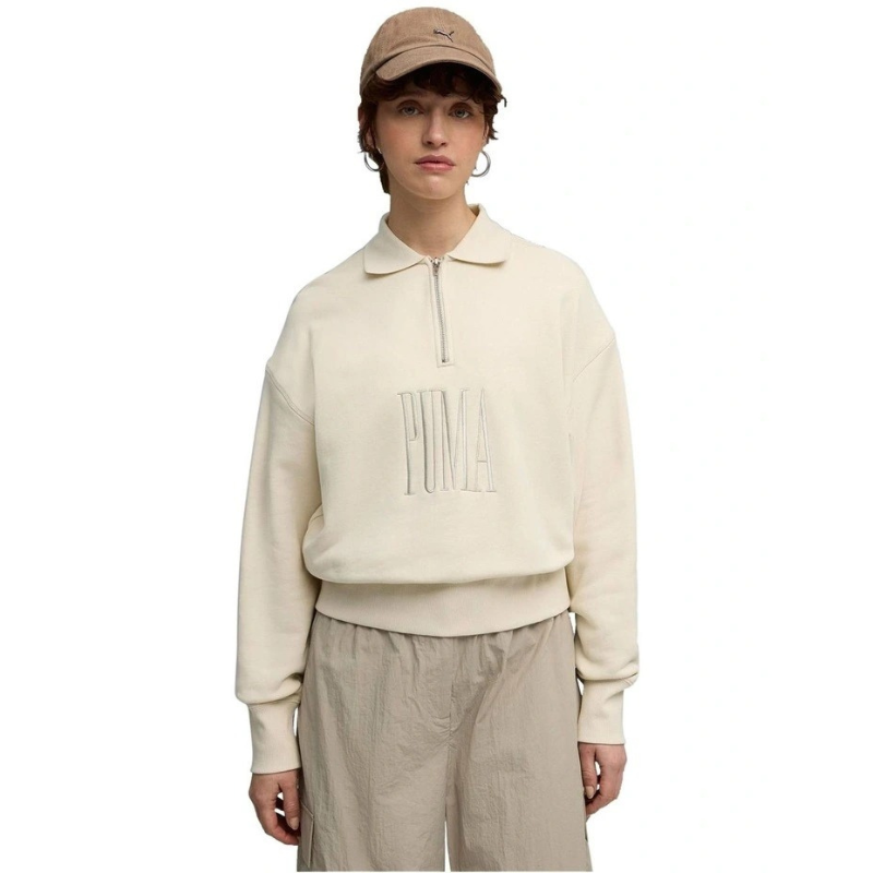 Person wearing a beige sweater with text and matching pants on a white background