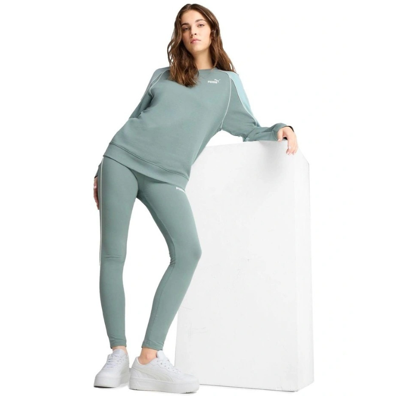 Woman wearing a green tracksuit with a white background