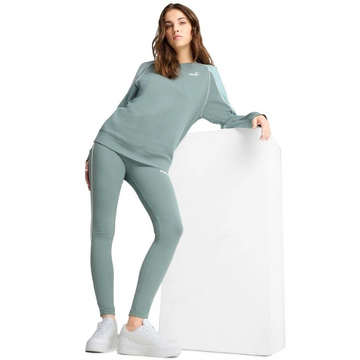 Woman wearing a green tracksuit with a white background