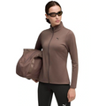 Woman wearing a brown athletic jacket and black leggings with a duffel bag on a white background