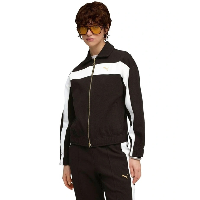 Person wearing a black and white tracksuit with a brand logo on a white background