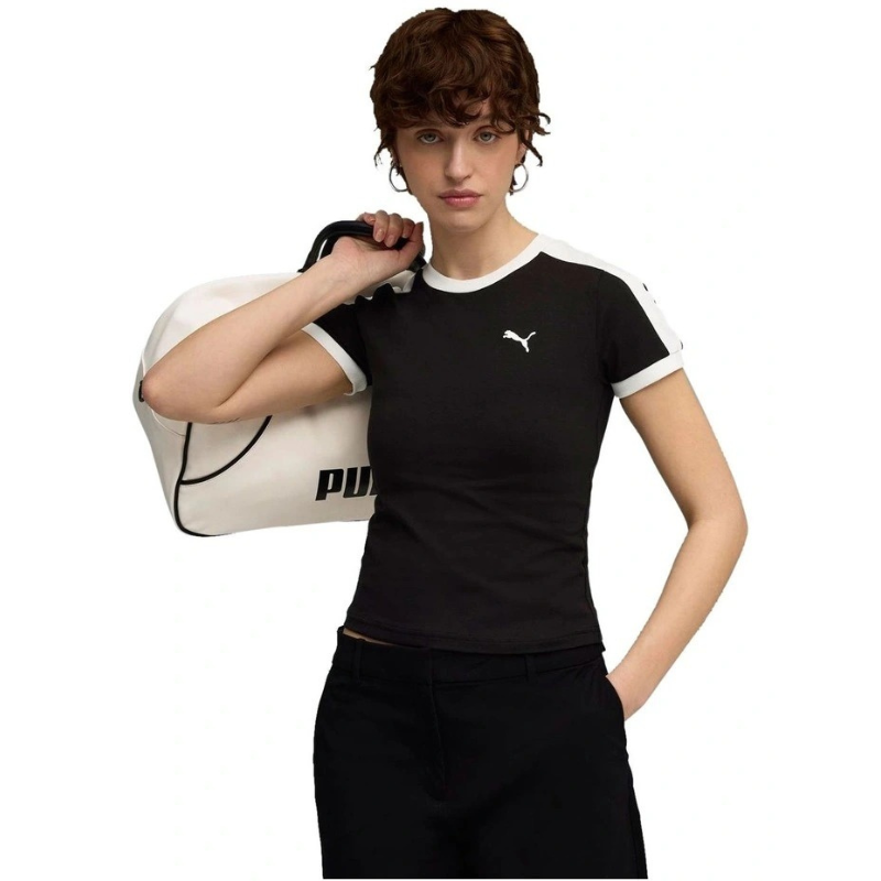 Person wearing a black Puma t-shirt holding a white duffel bag on a white background