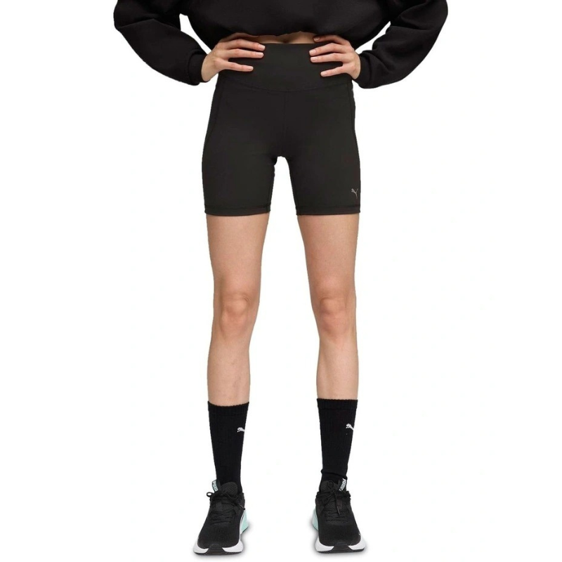 Person wearing black athletic shorts and socks on a white background
