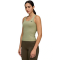 Woman wearing a green tank top with a brand logo on a white background