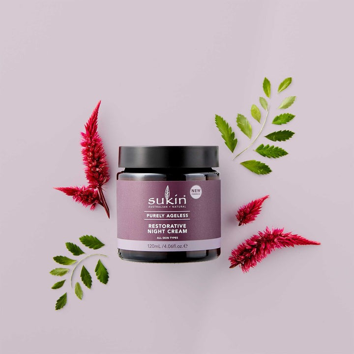 Sukin skincare product jar with flowers and leaves on a light purple background