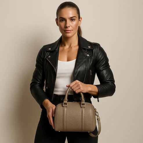 Beige genuine leather barrel shoulder bag with adjustable strap, minimalist design, and premium handcrafted finish.