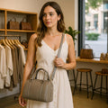 Beige genuine leather barrel shoulder bag with adjustable strap, minimalist design, and premium handcrafted finish.