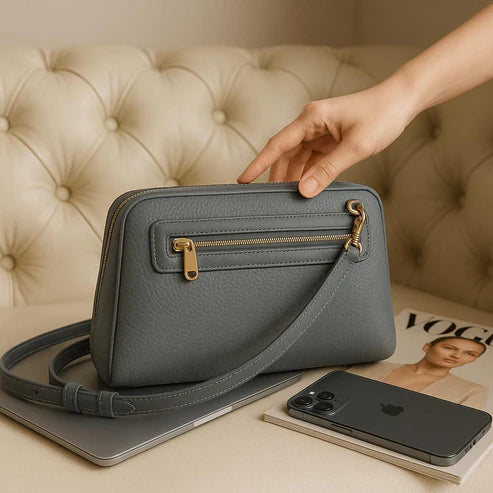 Elegant gray leather clutch bag by LeatherLuxe, featuring a minimalist design with detachable crossbody strap, premium stitching, and gold-tone hardware.