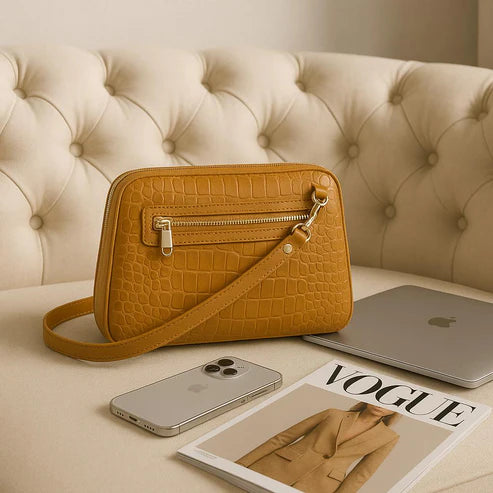 Light brown leather clutch bag with crocodile-style texture, crossbody shoulder strap, and elegant design — LeatherLuxe women’s handbag.