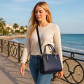 Navy blue women’s genuine leather handbag with shoulder and crossbody strap — elegant and stylish design for everyday use.