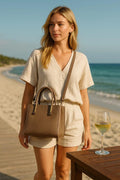 LeatherLuxe beige women's leather handbag with adjustable shoulder strap, elegant crossbody design, perfect for casual and formal use.