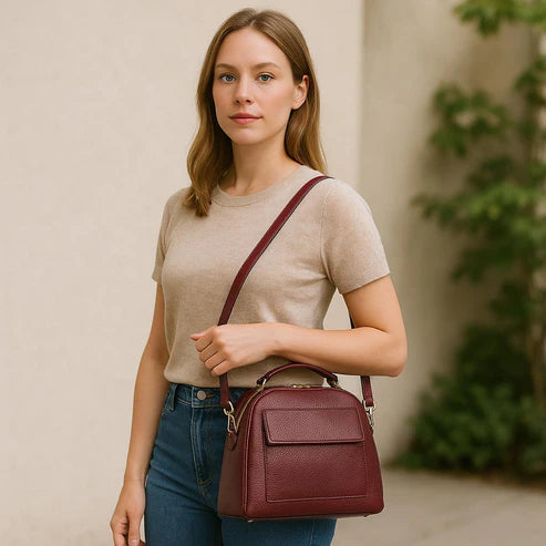 Elegant dark red genuine leather women’s satchel handbag with structured medium design and gold-tone accents — perfect for everyday and office wear.