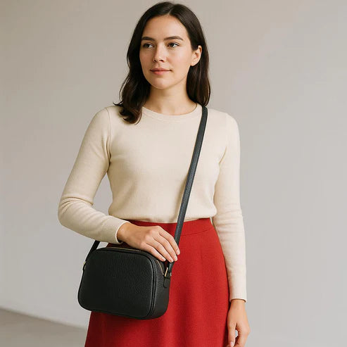 Premium black leather crossbody shoulder bag with adjustable strap, sleek minimalist design, and high-quality stitching for everyday use.