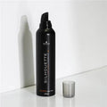 Black hair mousse bottle labeled 'Silhouette' on a white background