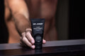 Virtue men’s skincare set with cleanser, exfoliator, moisturizer, face mask, and serum in sleek black packaging displayed with male models