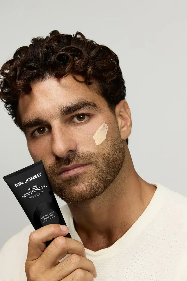 Virtue men’s skincare set with cleanser, exfoliator, moisturizer, face mask, and serum in sleek black packaging displayed with male models