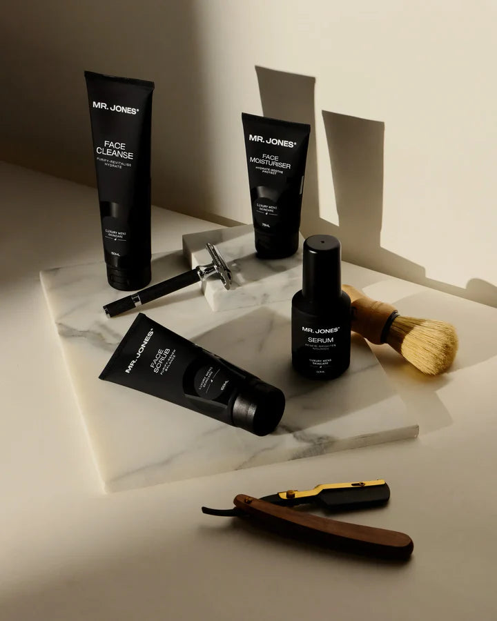 Virtue men’s skincare set with cleanser, exfoliator, moisturizer, face mask, and serum in sleek black packaging displayed with male models
