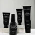 Virtue men’s skincare set with cleanser, exfoliator, moisturizer, face mask, and serum in sleek black packaging displayed with male models