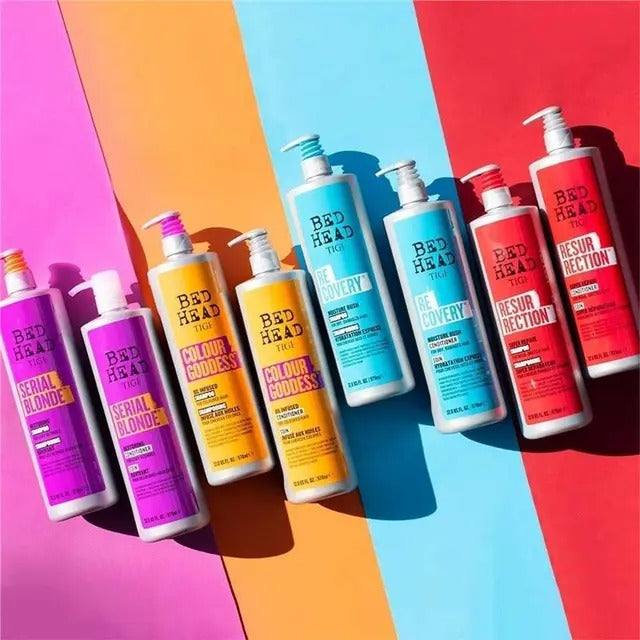 Collection of Bed Head hair care products on a colorful background