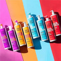 Collection of Bed Head hair care products on a colorful background