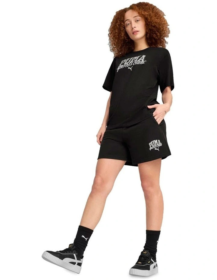 Person wearing a black Puma sports club t-shirt on a white background