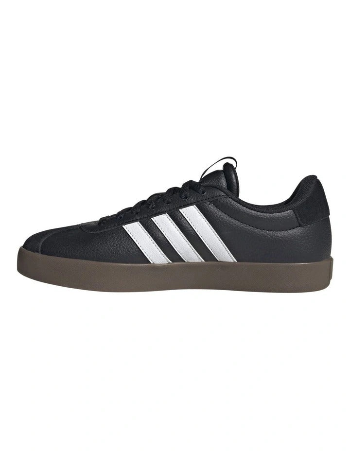 Black Adidas sneaker with white stripes on a white background