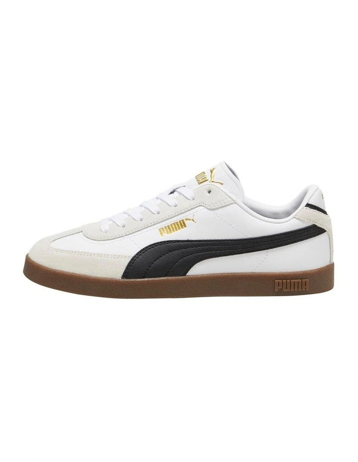 White sneaker with black accent and brown sole on a white background