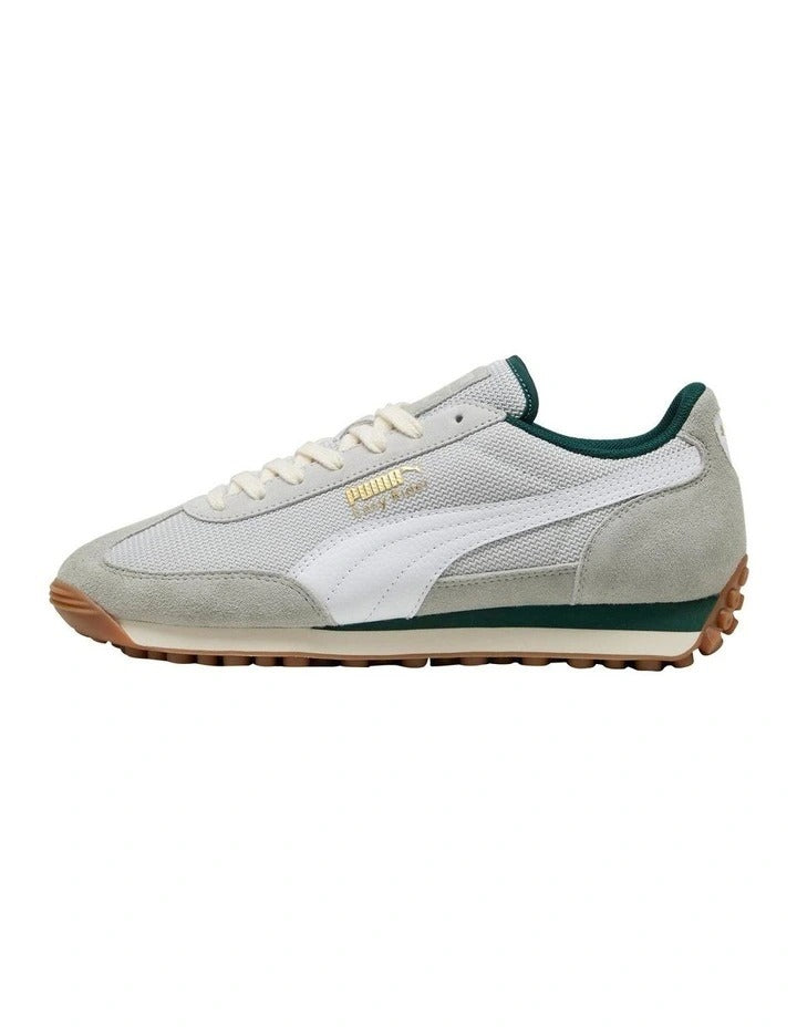 Sneaker with green accents on a white background