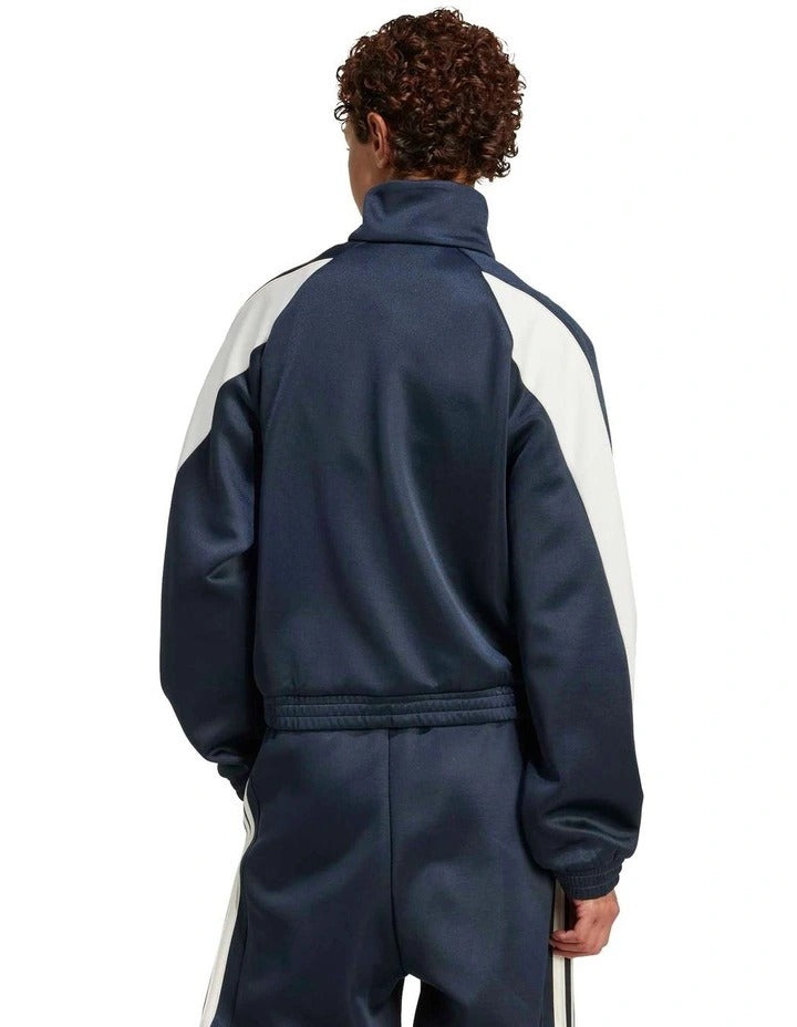Adidas Stadium Tracktop with recycled polyester and cotton blend, soft knit fabric, satin piping, zip pockets, and 3 Bar Logo design