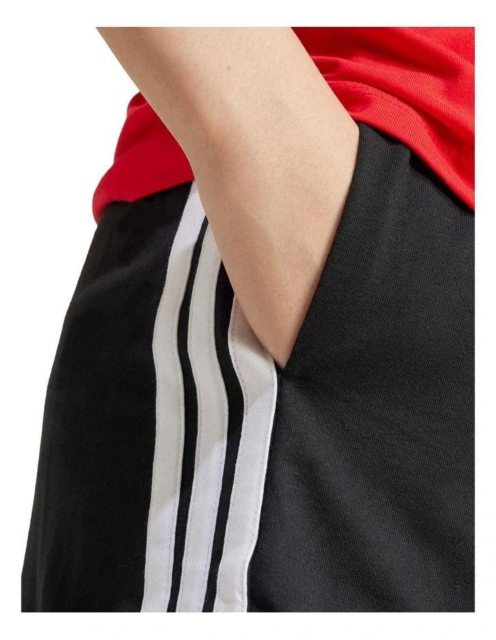 Adidas Essentials 3-Stripes Cotton Shorts in black with signature sporty side stripes, made from soft cotton and elastane for everyday comfort
