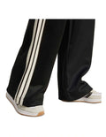 Adidas Stadium Stripes Tracksuit Bottoms in black with signature 3-Stripes, soft recycled polyester-cotton blend, satin piping, and matte rubber-print logo.
