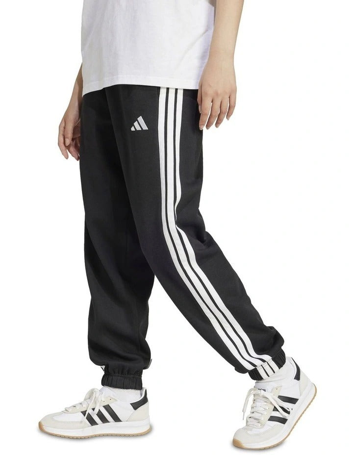 Adidas Essentials 3-Stripes Fleece Loose-Fit Joggers in grey, cozy casual pants with iconic side stripes, made from recycled cotton and polyester blend