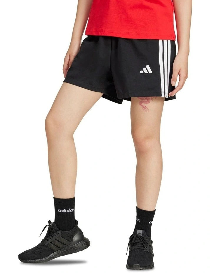 Adidas Essentials 3-Stripes Cotton Shorts in black with signature sporty side stripes, made from soft cotton and elastane for everyday comfort