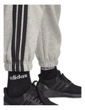 Adidas Essentials 3-Stripes Fleece Loose-Fit Joggers in grey, cozy casual pants with iconic side stripes, made from recycled cotton and polyester blend