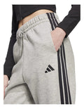 Adidas Essentials 3-Stripes Fleece Loose-Fit Joggers in grey, cozy casual pants with iconic side stripes, made from recycled cotton and polyester blend