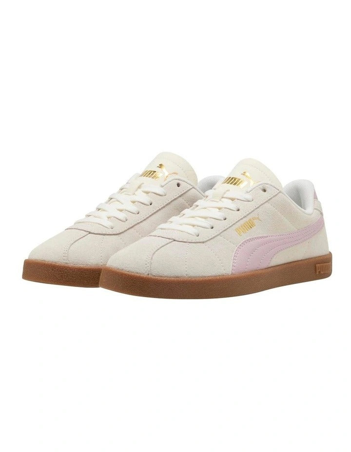 White sneakers with pink accents and brown soles on a white background